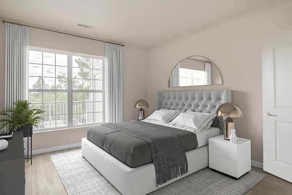 Bright and elegant bedroom with large window, plush bed, and stylish decor featuring a gold lamp.