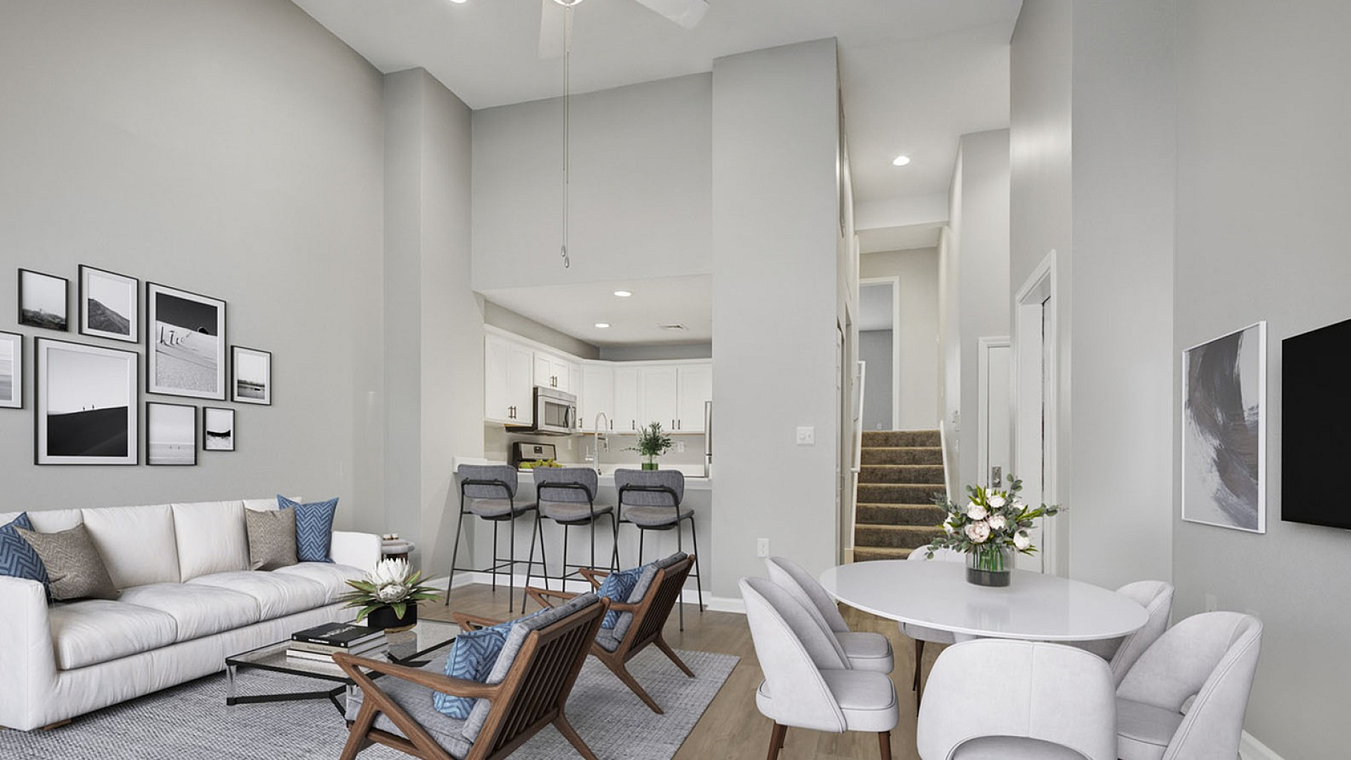 Chic and modern apartment living room with stylish decor, comfortable seating, and open-concept kitchen, perfect for entertaining.