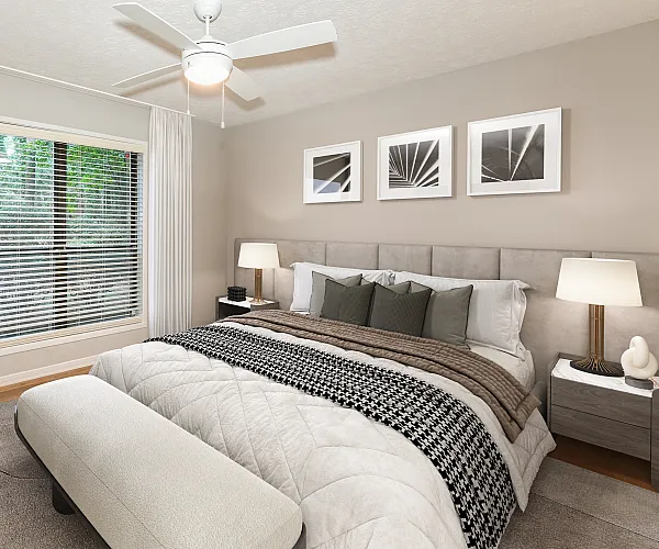 Elegant bedroom featuring a plush bed, stylish artwork, and a large window with lush greenery view.