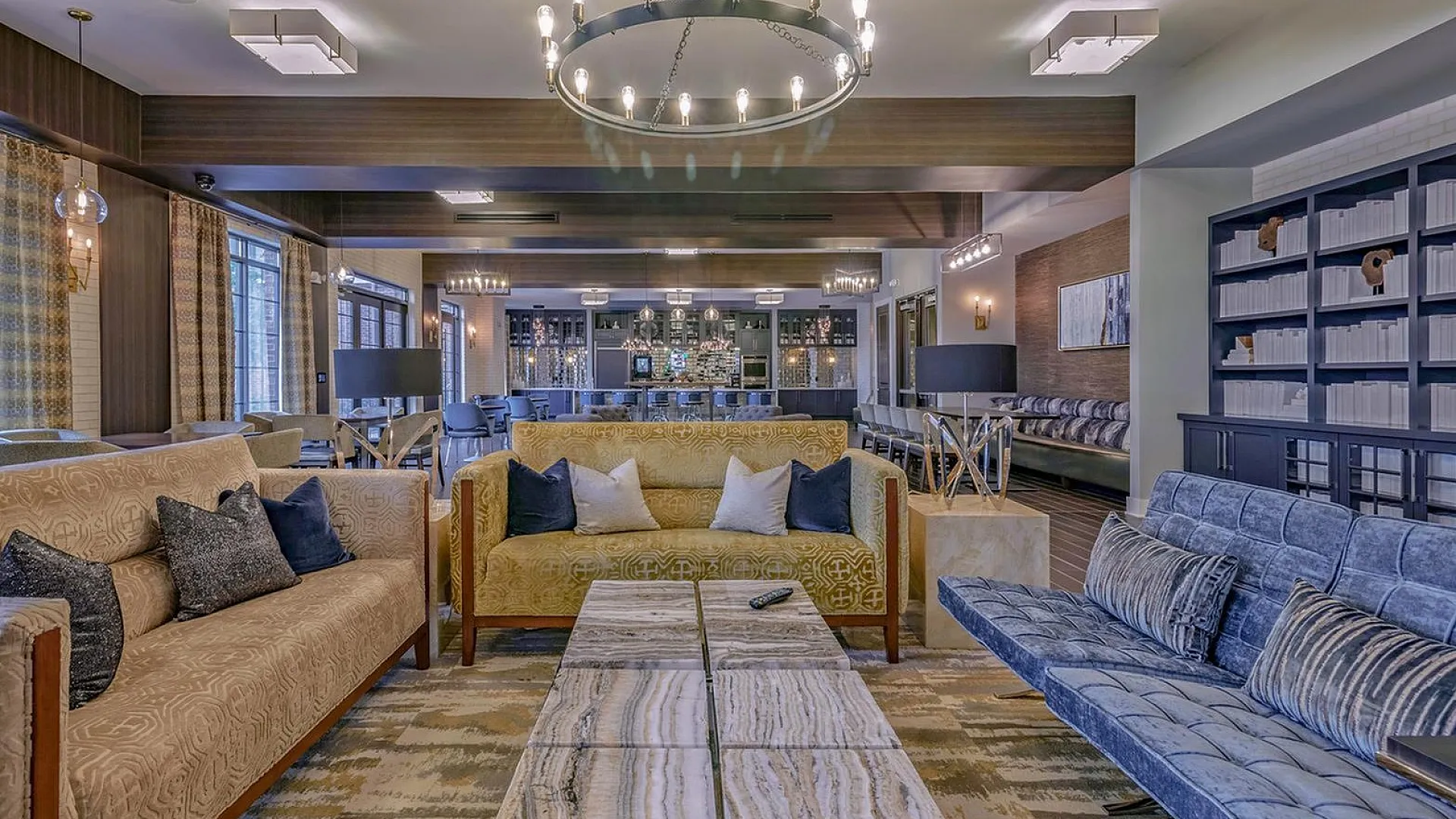 Elegant open-concept living area with plush seating, modern chandeliers, and a stylish communal space for relaxation and socializing.