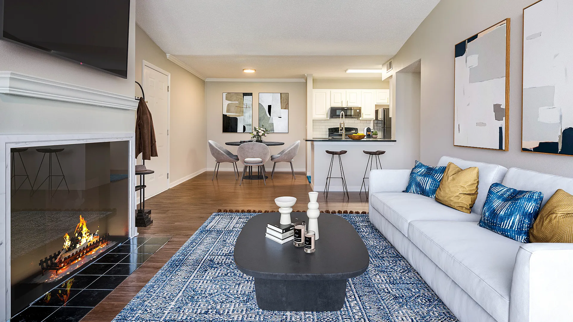 Elegant open-concept living space with cozy fireplace, modern kitchen, and stylish decor, ideal for comfortable living.