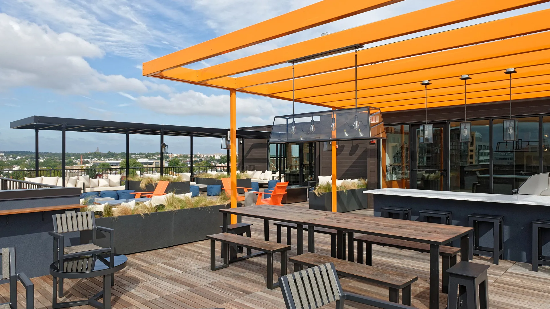 Modern rooftop terrace featuring stylish pergolas, chic seating, and stunning city views perfect for relaxing and entertaining.