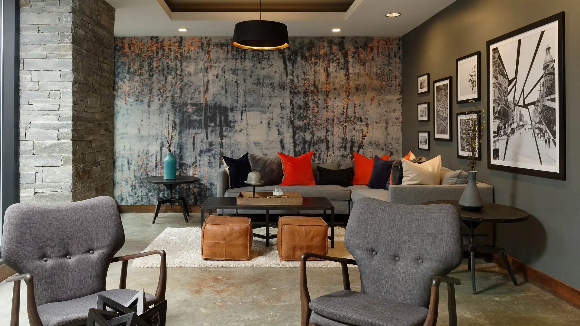 Chic modern living room with stylish decor, vibrant cushions, and artistic wall highlights, creating a cozy yet sophisticated ambiance.