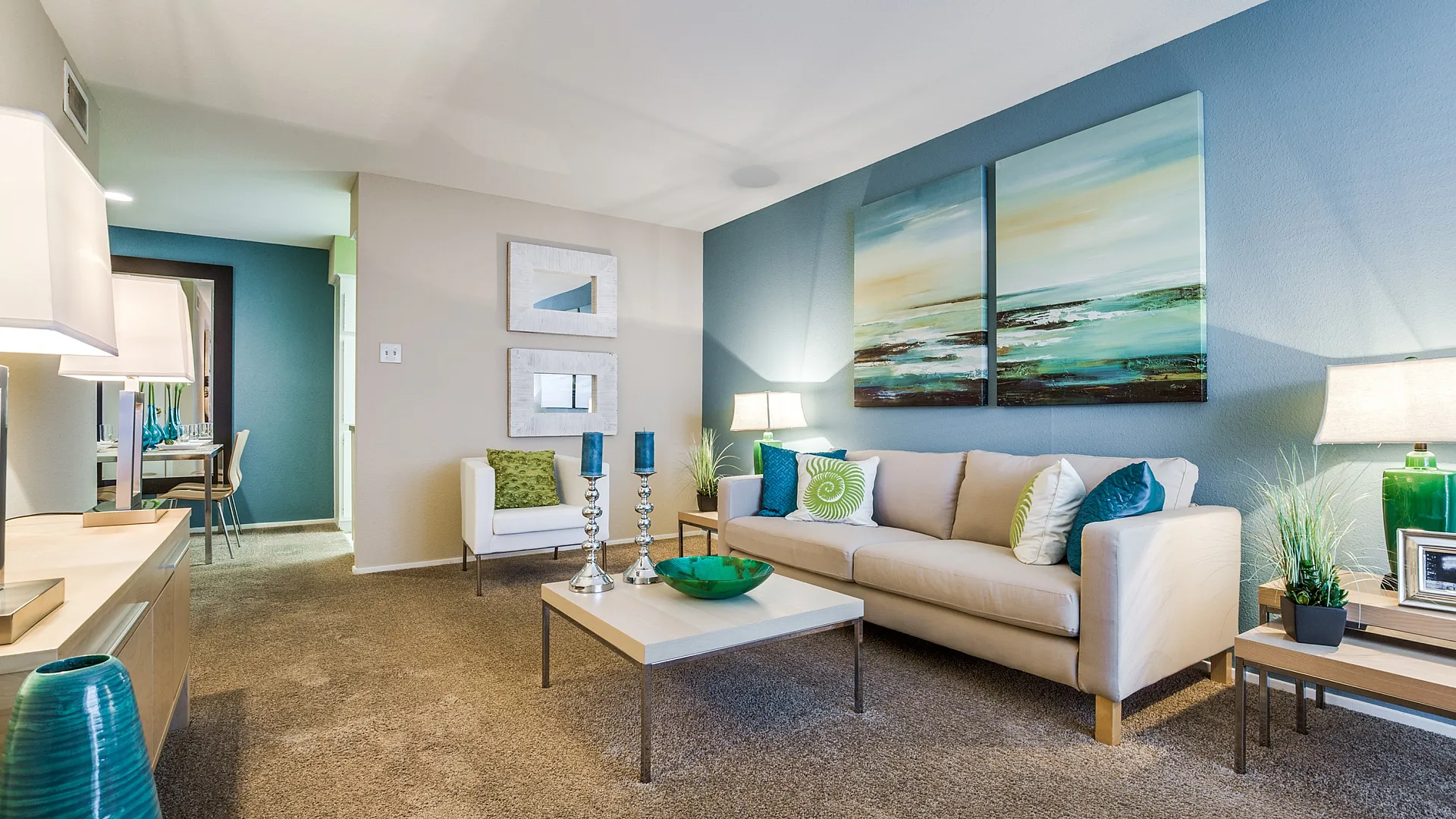 Elegant living room with chic decor, featuring a cozy beige sofa, modern art piece, and bright accents perfect for relaxation.