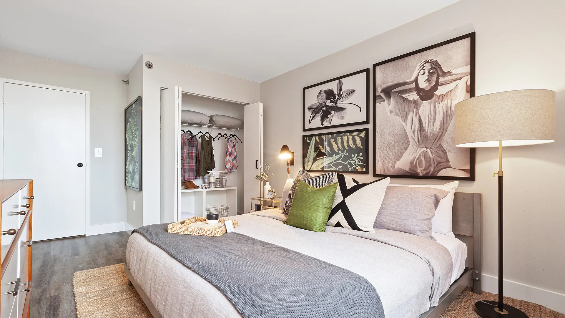 Inviting bedroom with modern decor, stylish artwork, and ample closet space for a cozy living experience.