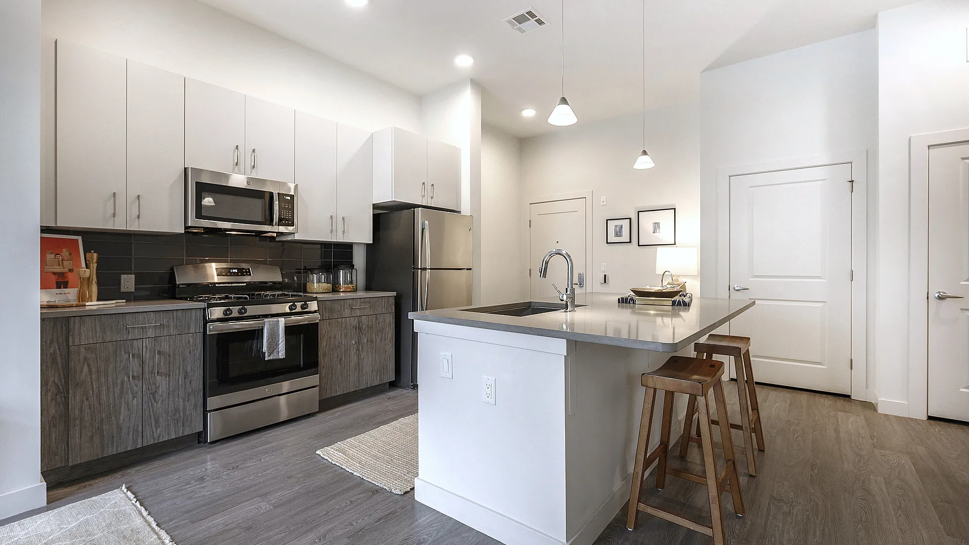 Modern kitchen with sleek stainless steel appliances, elegant cabinetry, and a spacious island with seating.