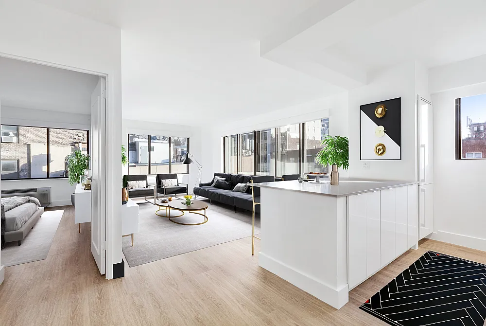 Spacious and modern open-plan apartment featuring a sunlit living area with sleek furnishings, contemporary kitchen, and a cozy bedroom.