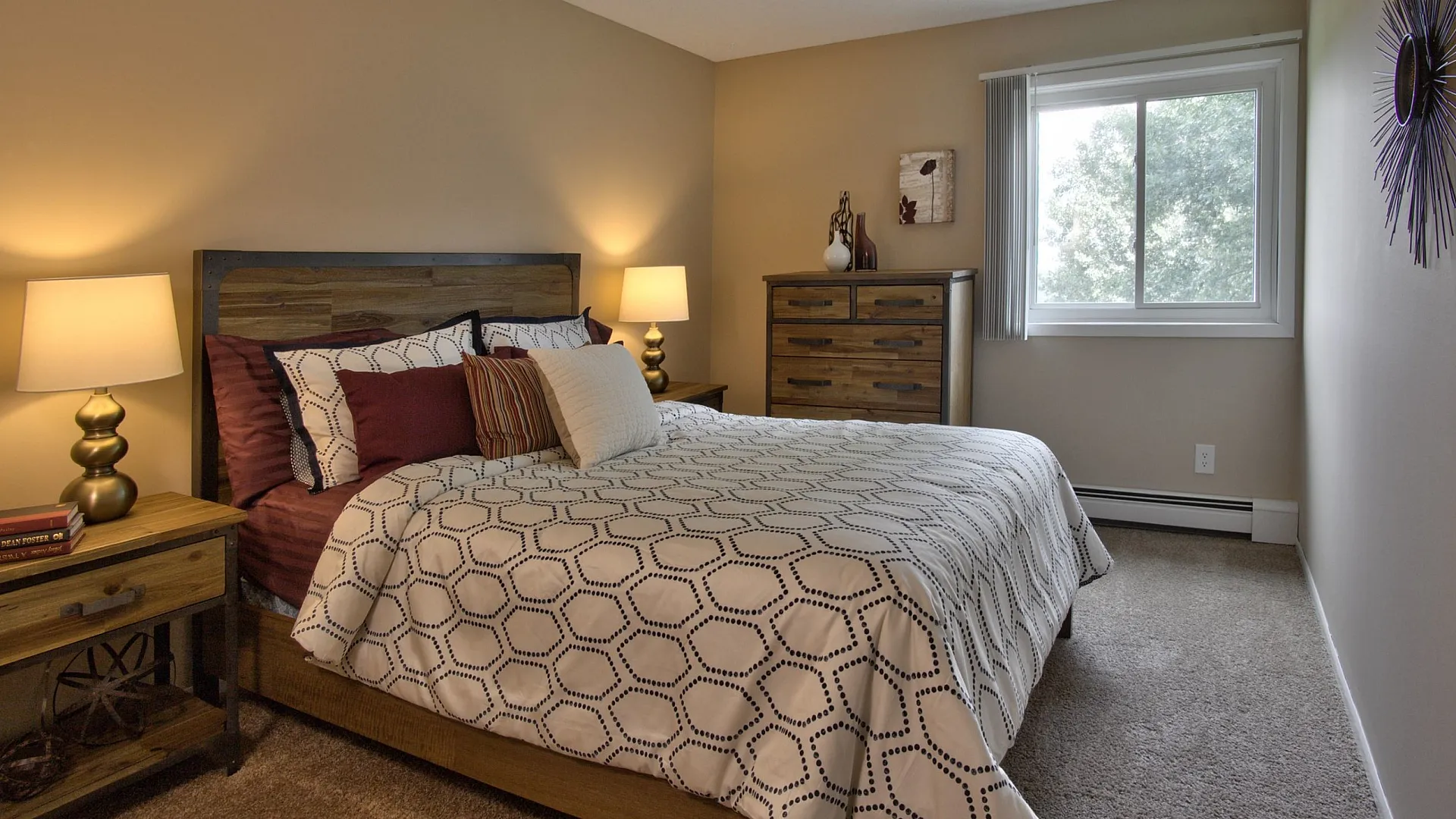 Cozy bedroom featuring a stylish wooden bed frame, elegant bedding, and warm lighting, with a scenic view from the window.
