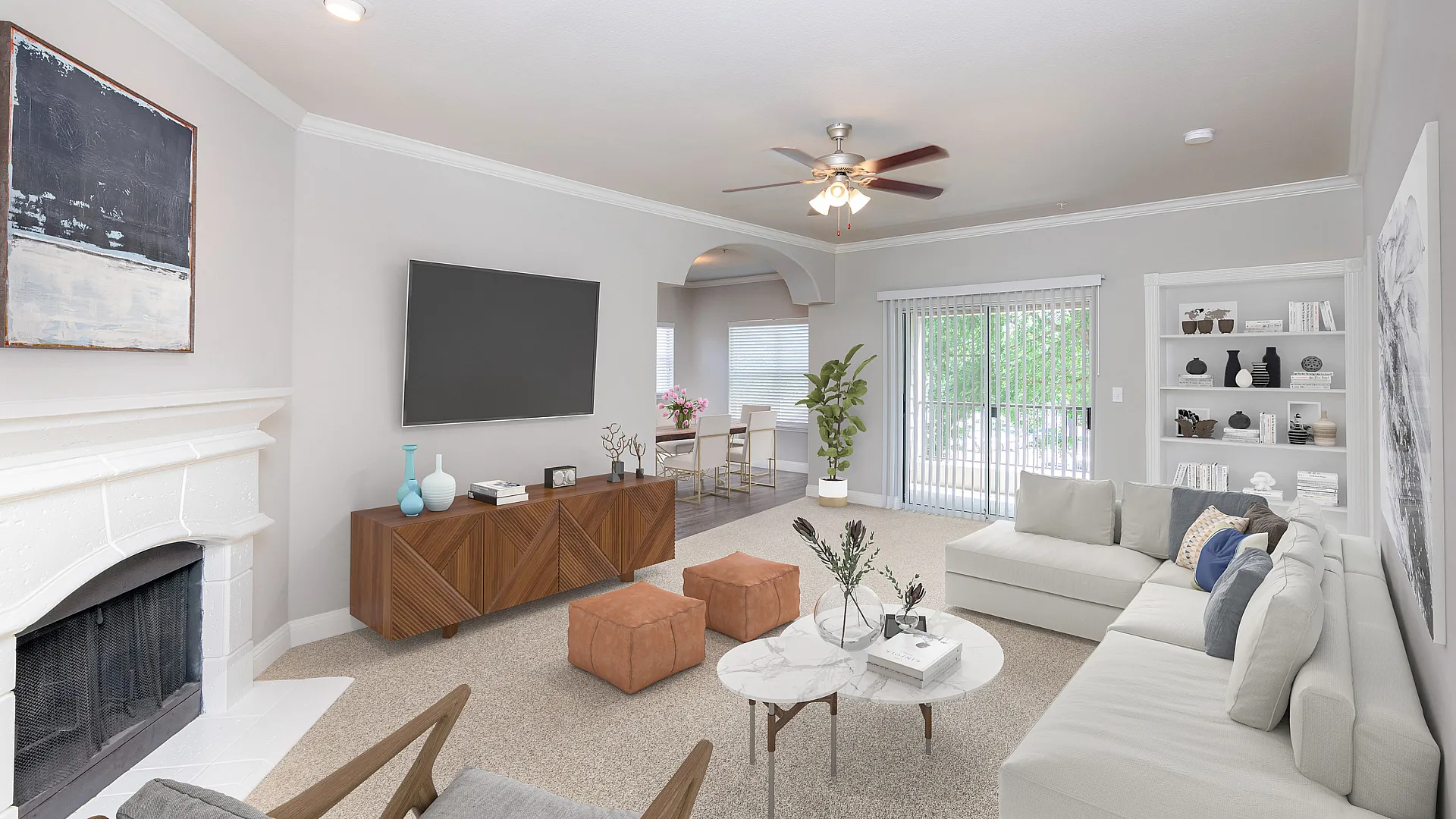 Elegant living room with modern decor, featuring a cozy sectional sofa, chic marble coffee table, and stylish entertainment unit. Bright dining area and natural light from large sliding doors create an inviting ambiance.
