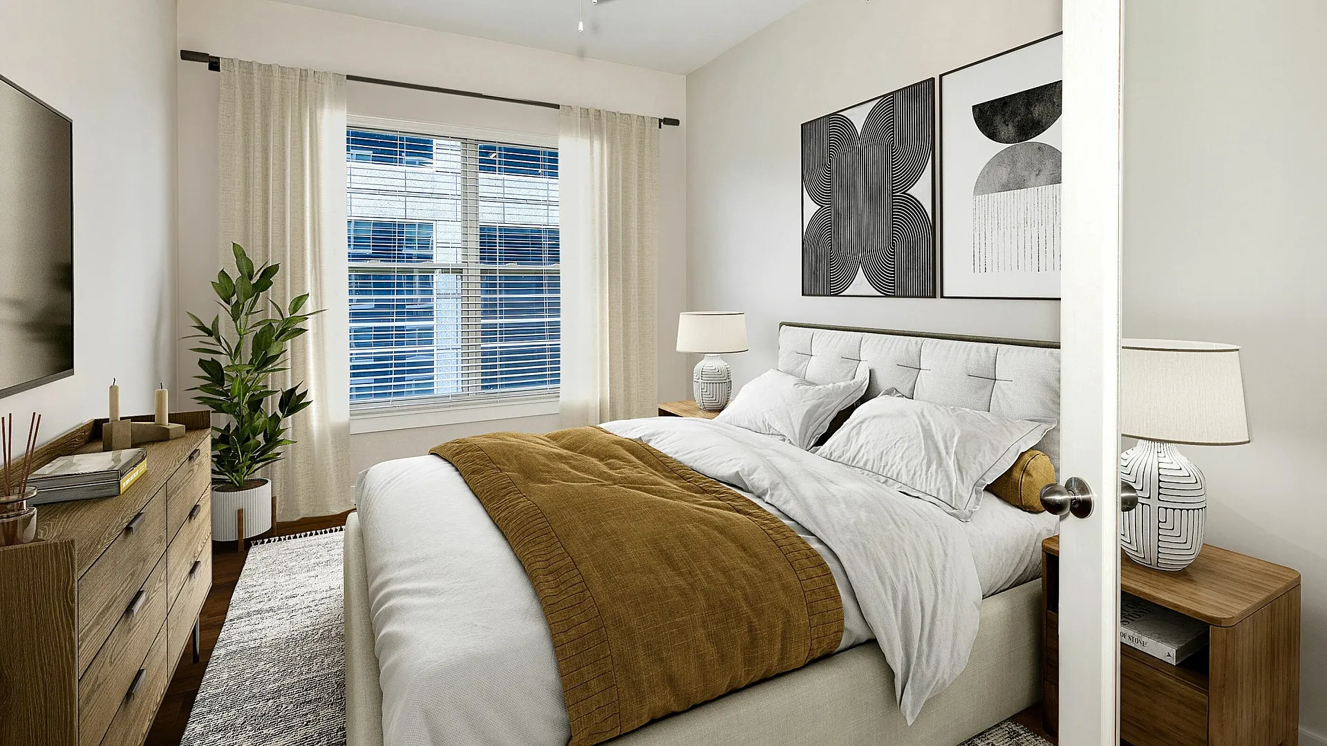 Cozy bedroom with modern decor featuring a plush bed, artistic wall hangings, and a chic ceiling fan, illuminated by natural light filtering through large windows.