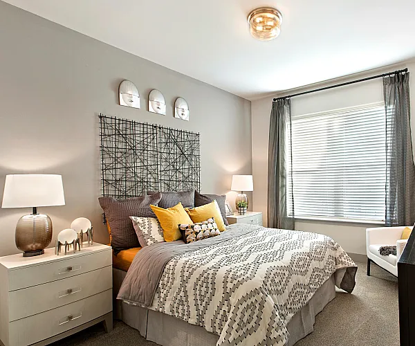 Inviting bedroom with modern decor, featuring a plush bed, warm lighting, and stylish accents for a cozy ambiance.