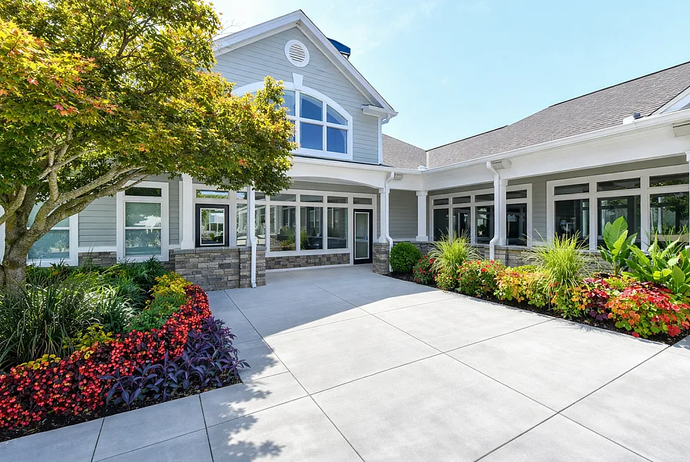 Inviting residence with elegant architecture, large windows, and vibrant landscaped gardens offering a serene ambiance.