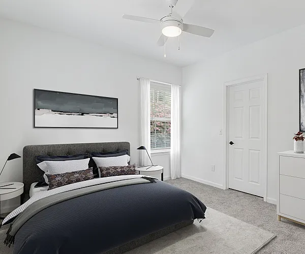 Modern bedroom with elegant decor, featuring a cozy bed, stylish artwork, and ample natural light, perfect for comfort and relaxation.