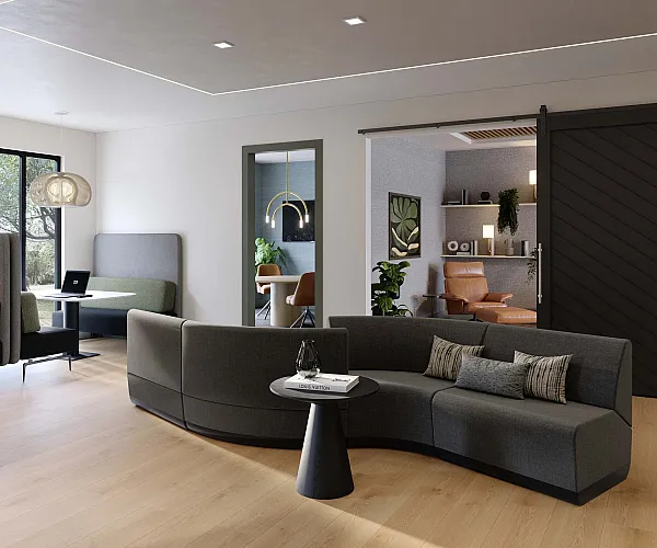 Modern co-working space featuring elegant seating, natural wood floors, and stylish pendant lighting.