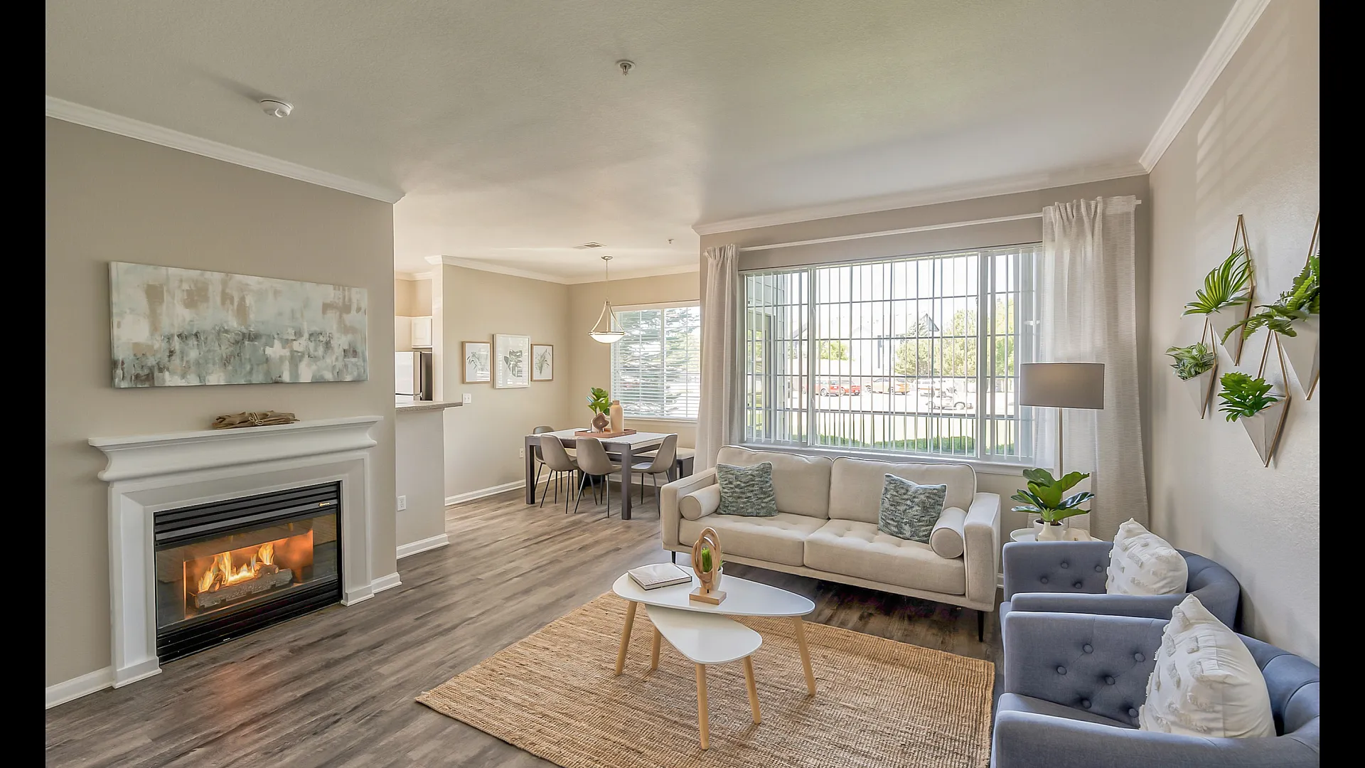 Bright and inviting living room with large windows, elegant fireplace, and stylish decor, perfect for relaxation and entertaining.