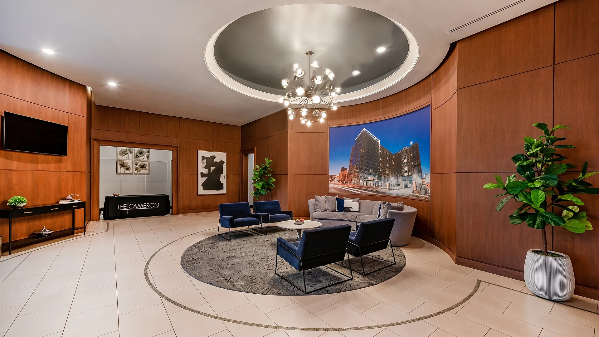 Luxurious apartment lobby featuring elegant seating area, modern chandelier, and stylish decor.