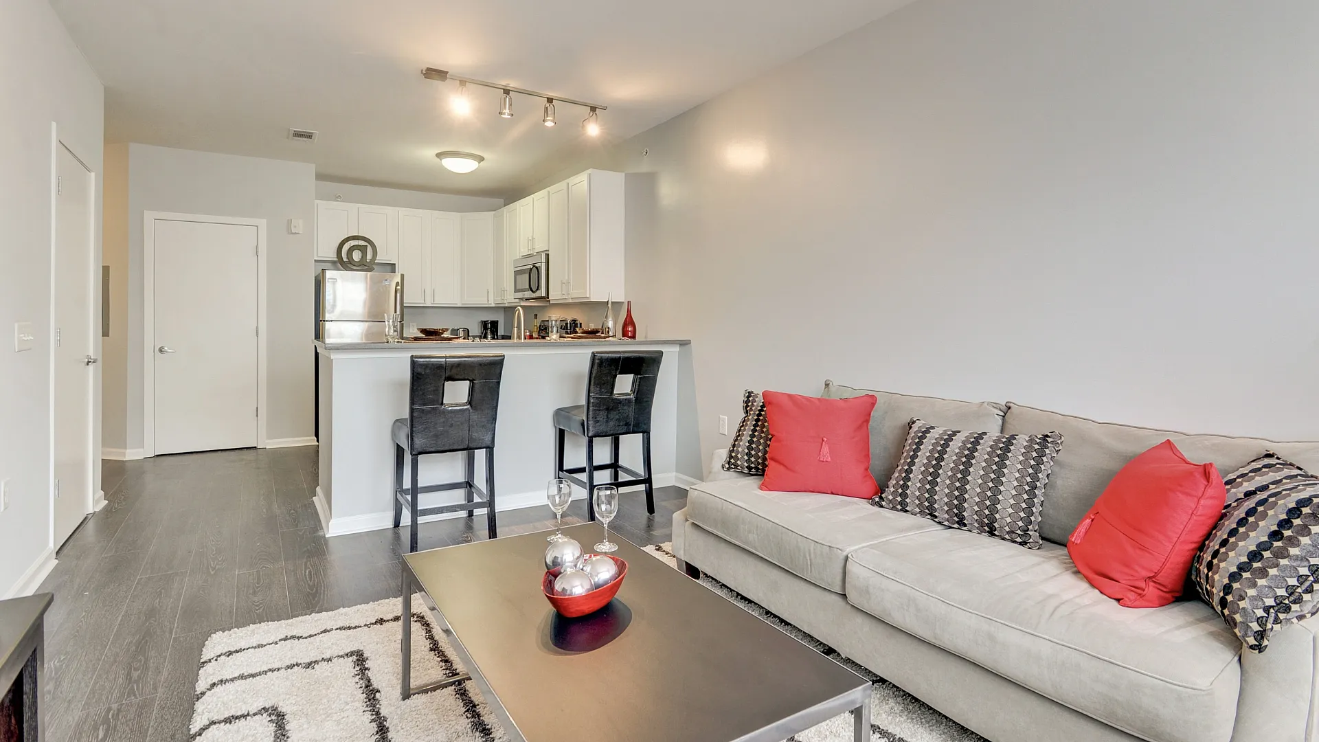 Modern open-concept living space with sleek kitchen, cozy seating area, and stylish decor.