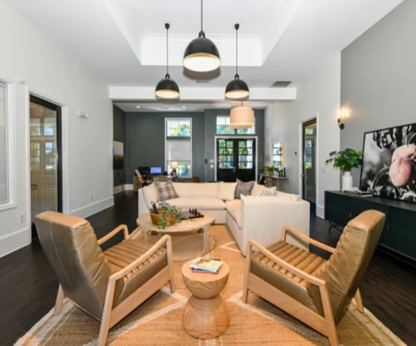Elegant and inviting modern living room featuring chic pendant lighting, stylish furnishings, and an open layout perfect for relaxation and entertaining.