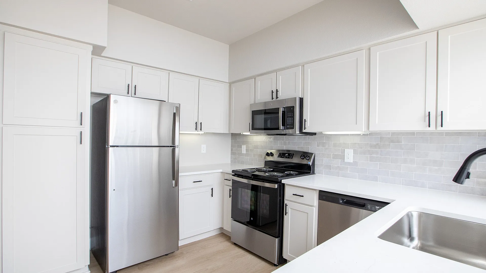 Updated kitchen with granite countertops and stainless steel appliances