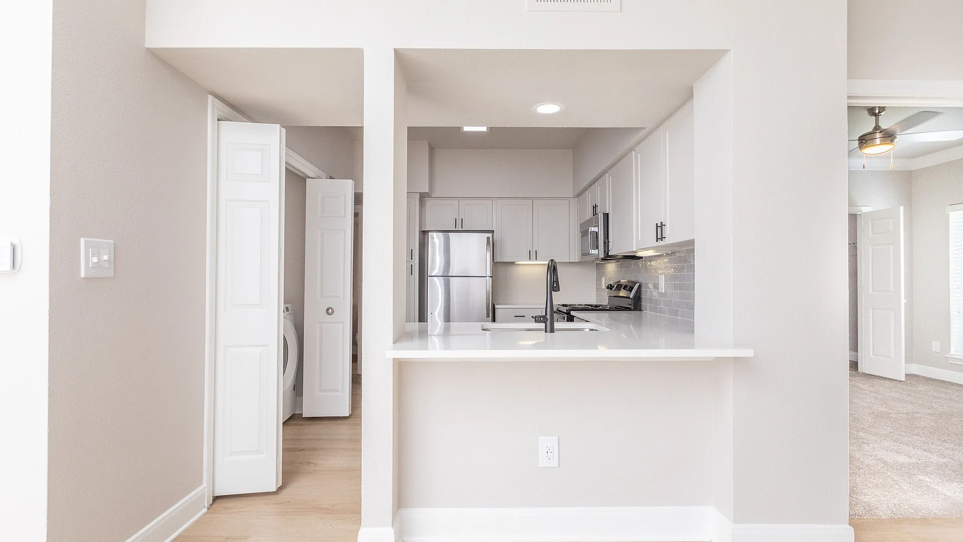 View of living room and kitchen with a bar