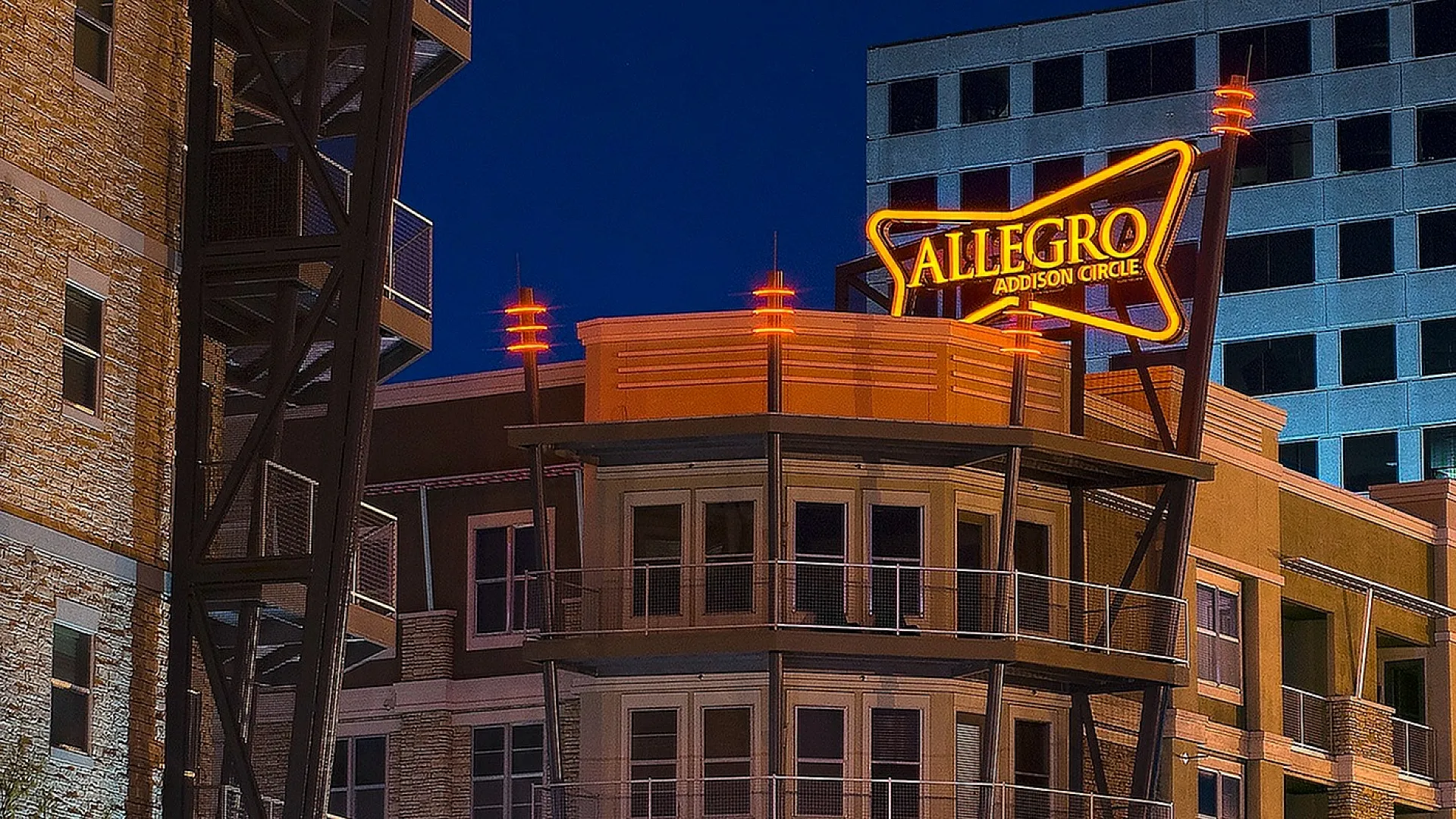 Vibrant night view of Allegro apartment complex with illuminated modern architecture and dynamic light trails enhancing the urban atmosphere.