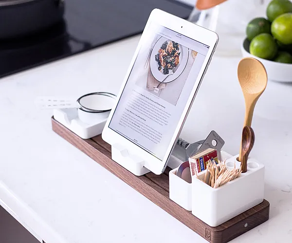 Modern kitchen countertop with chic tablet stand and elegant kitchen accessories, emphasizing a sophisticated cooking space.