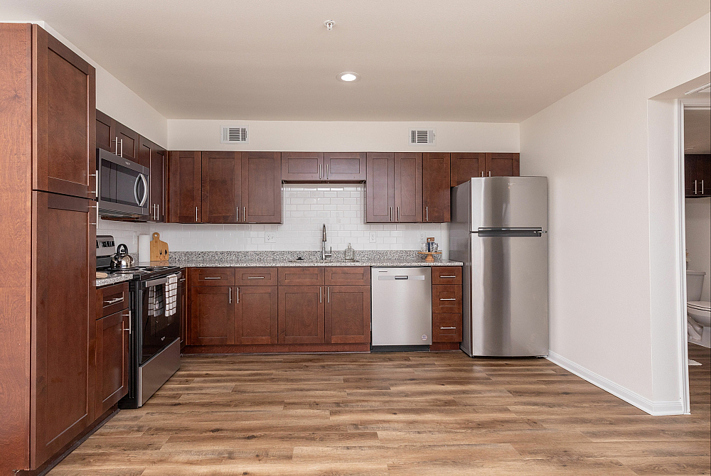 Elegant apartment interior showcasing a stylish dining area with modern decor, adjacent to a vibrant kitchen and cozy living space. Perfect for contemporary living.