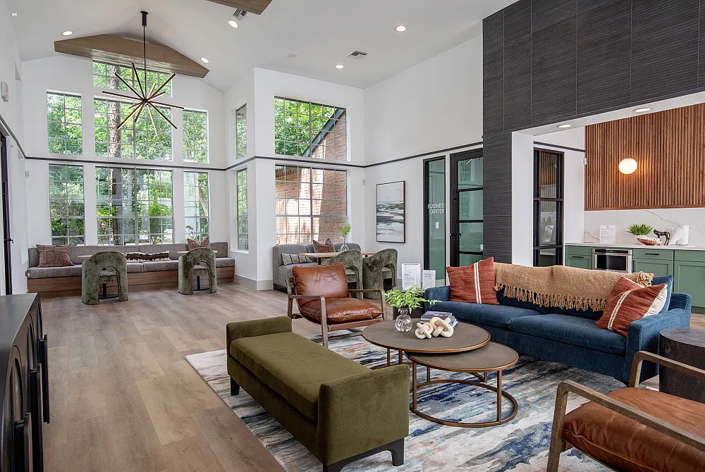 Spacious living area with large windows, modern furniture, and stylish decor, ideal for comfortable and elegant living.