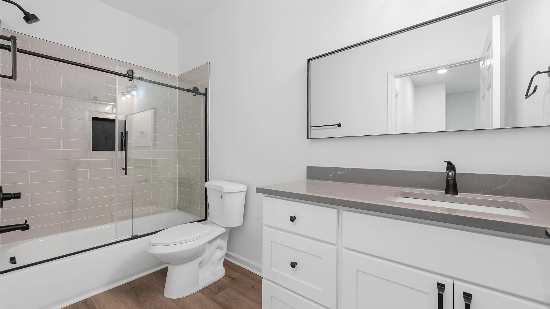 Modern bathroom with elegant glass shower, stylish tilework, and sleek vanity, perfect for a contemporary home.