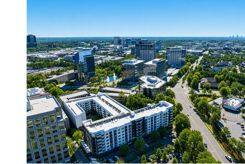Vibrant urban panorama showcasing modern architecture, lush green spaces, and convenient roadways, perfect for dynamic city living.