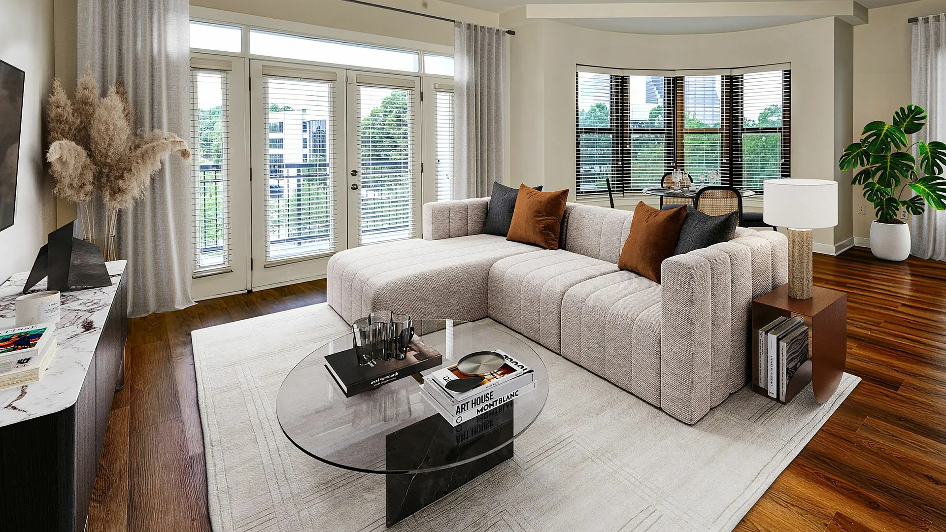 Elegant open living room with modern decor, featuring a plush sectional sofa, stylish coffee table, and large windows offering abundant natural light.
