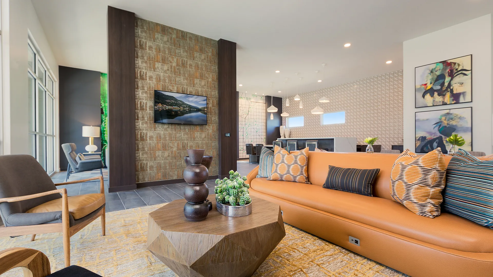 Modern living room with a chic orange sofa, vibrant cushions, and a geometric wooden coffee table. Contemporary art and wall decor enhance the stylish ambiance.