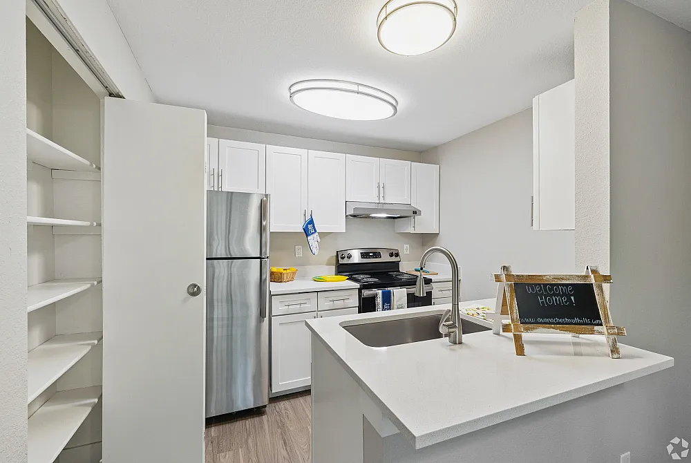Modern kitchen with sleek stainless steel appliances, elegant white cabinetry, and a welcoming vibe.