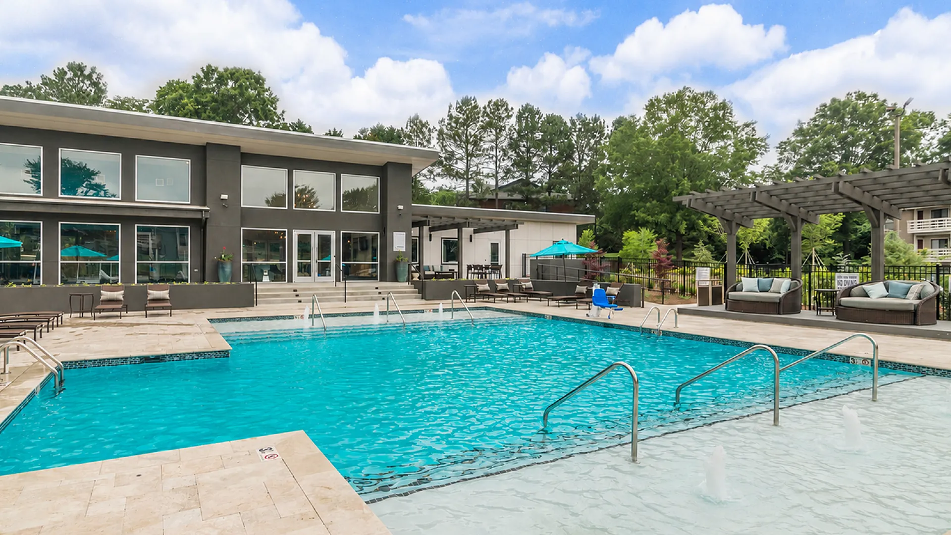 Luxurious outdoor swimming pool with elegant patio seating and vibrant landscaping, perfect for relaxation and entertaining.