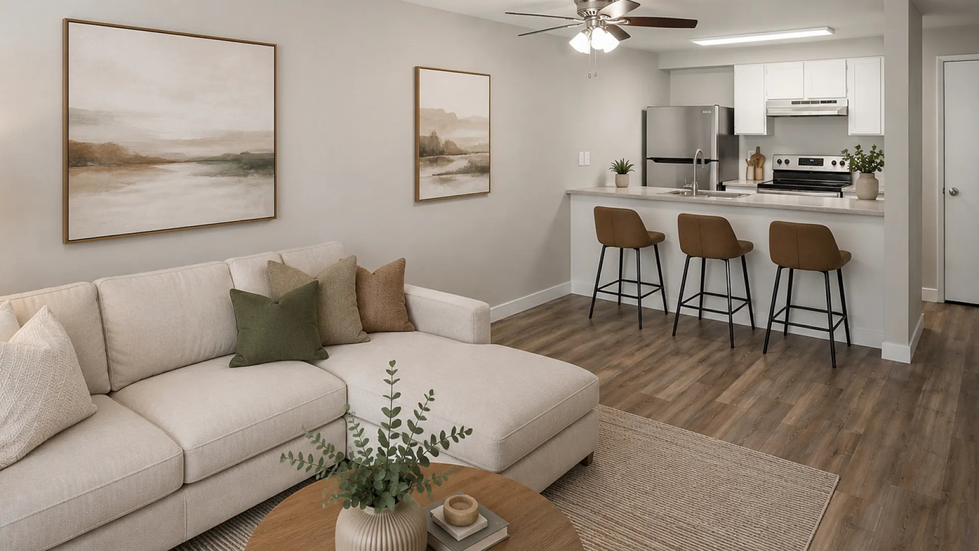 Modern living room with sleek beige sectional, wooden coffee table, and stylish open kitchen with breakfast bar seating.