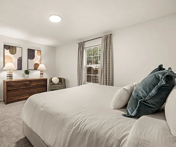 Inviting bedroom featuring a plush bed, stylish decor, and soft lighting, perfect for relaxation.