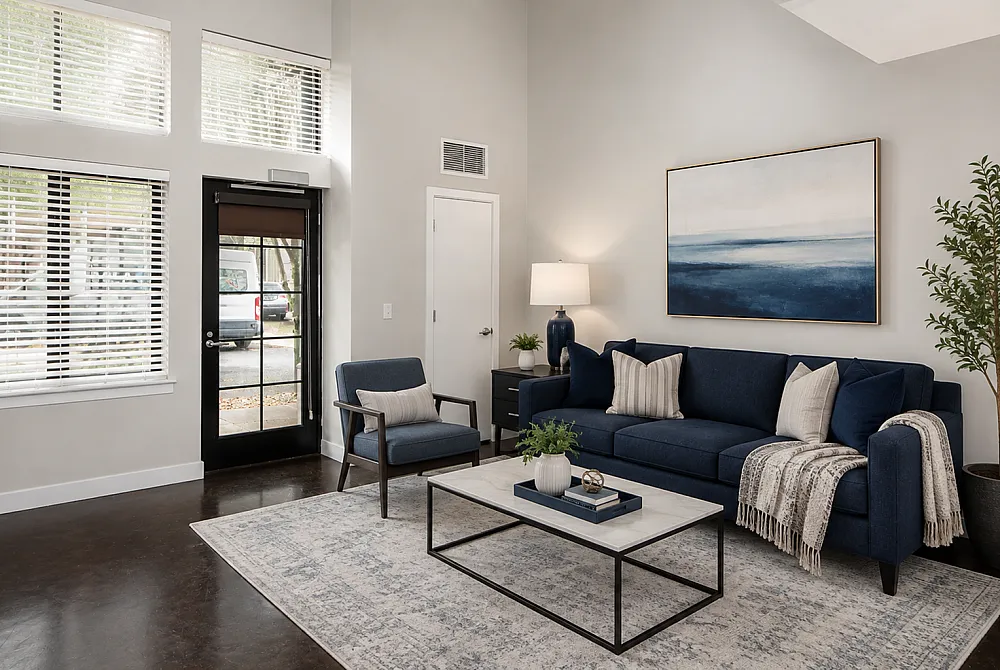 Modern living room with elegant blue sofa, stylish armchair, and contemporary artwork, creating a cozy and sophisticated ambiance.