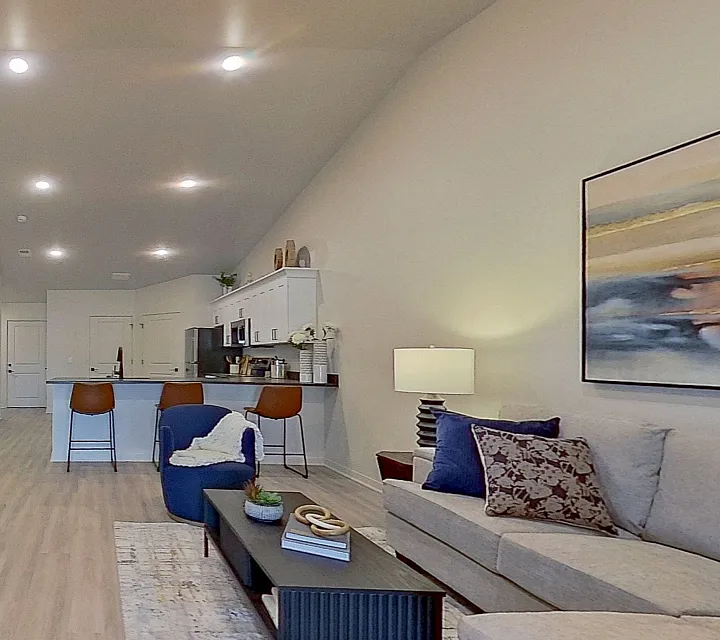 Contemporary Lombardo Apartments living room with open-concept kitchen, stylish decor, and inviting seating area.