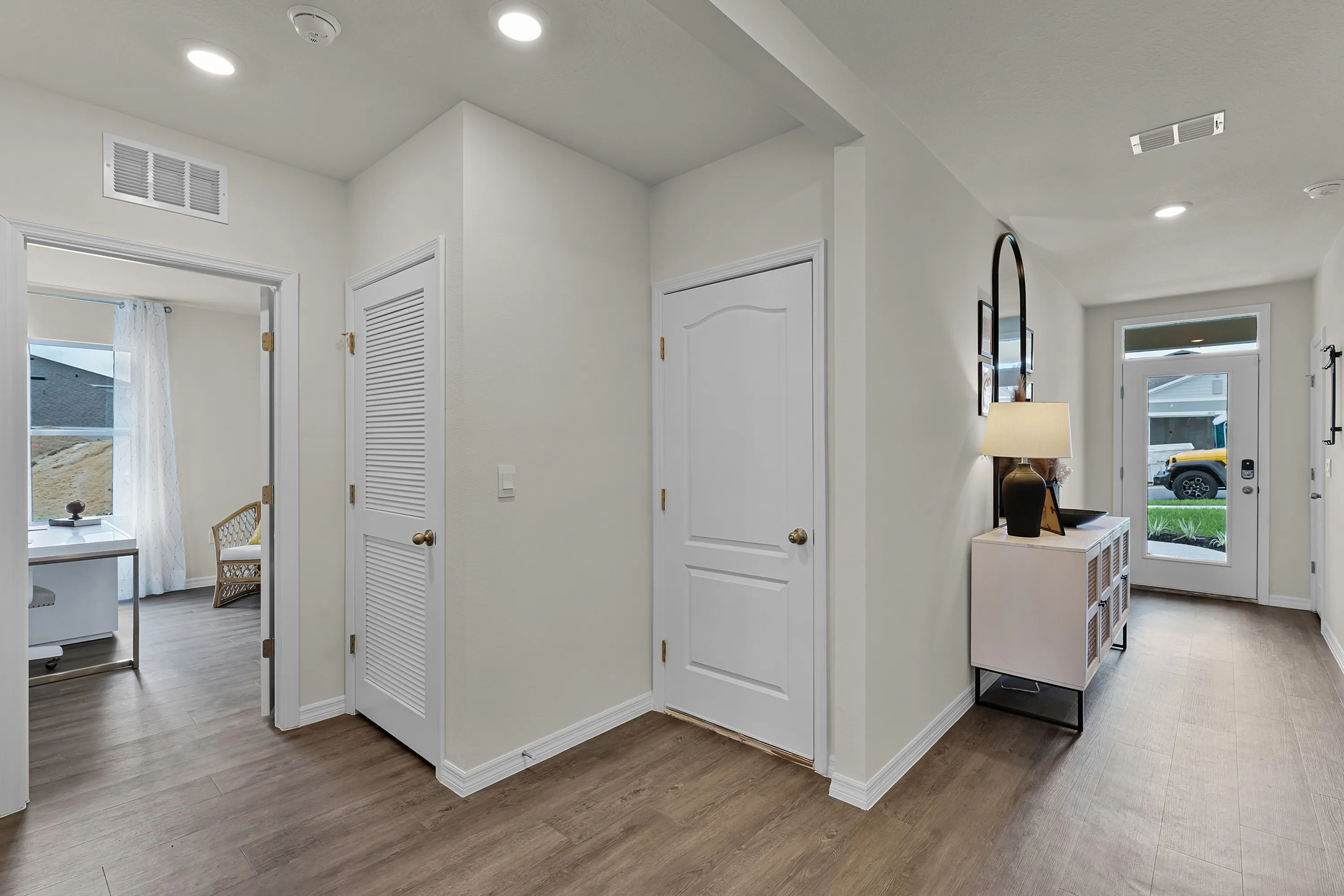 Inviting entryway with wood-style flooring and modern finishes.