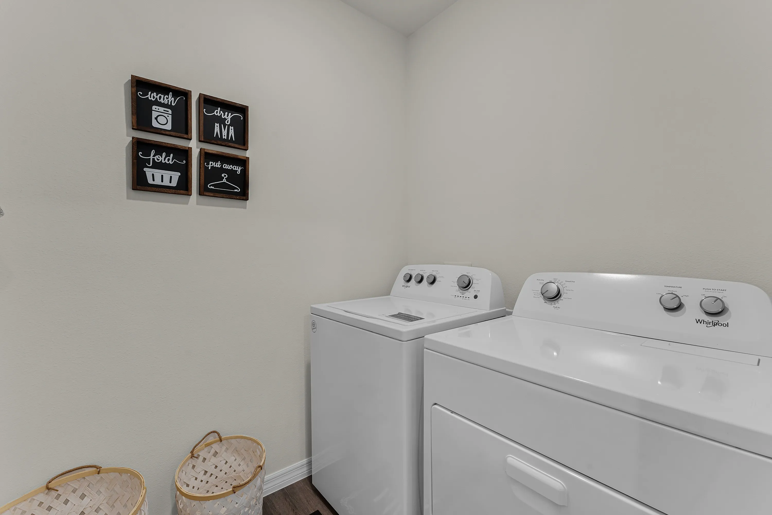 Spacious laundry room with full-size washer and dryer.