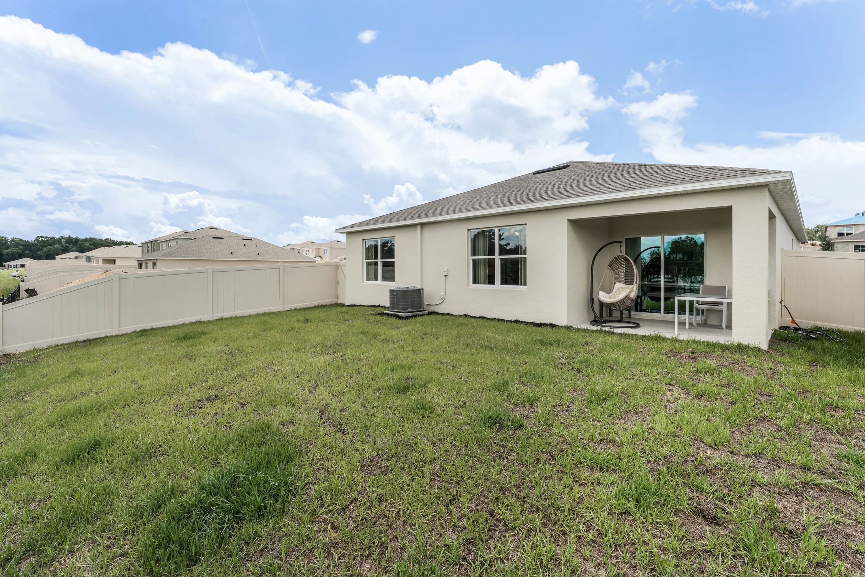 Spacious backyard with covered patio—perfect for lounging or entertaining.