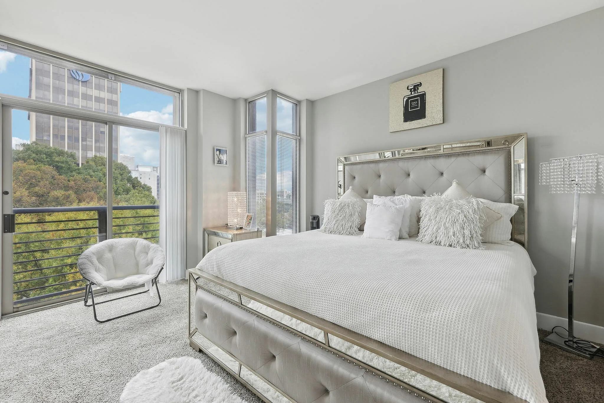Bedroom with floor-to-ceiling windows and city views