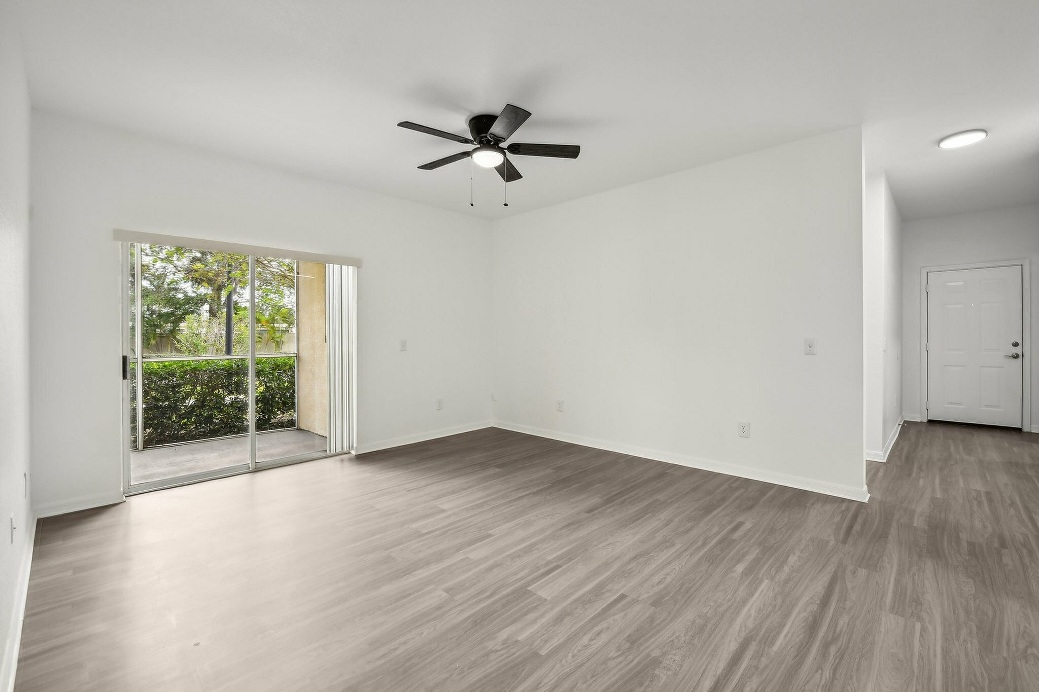 interior pic of deluxe unit living room with gray planking and white walls