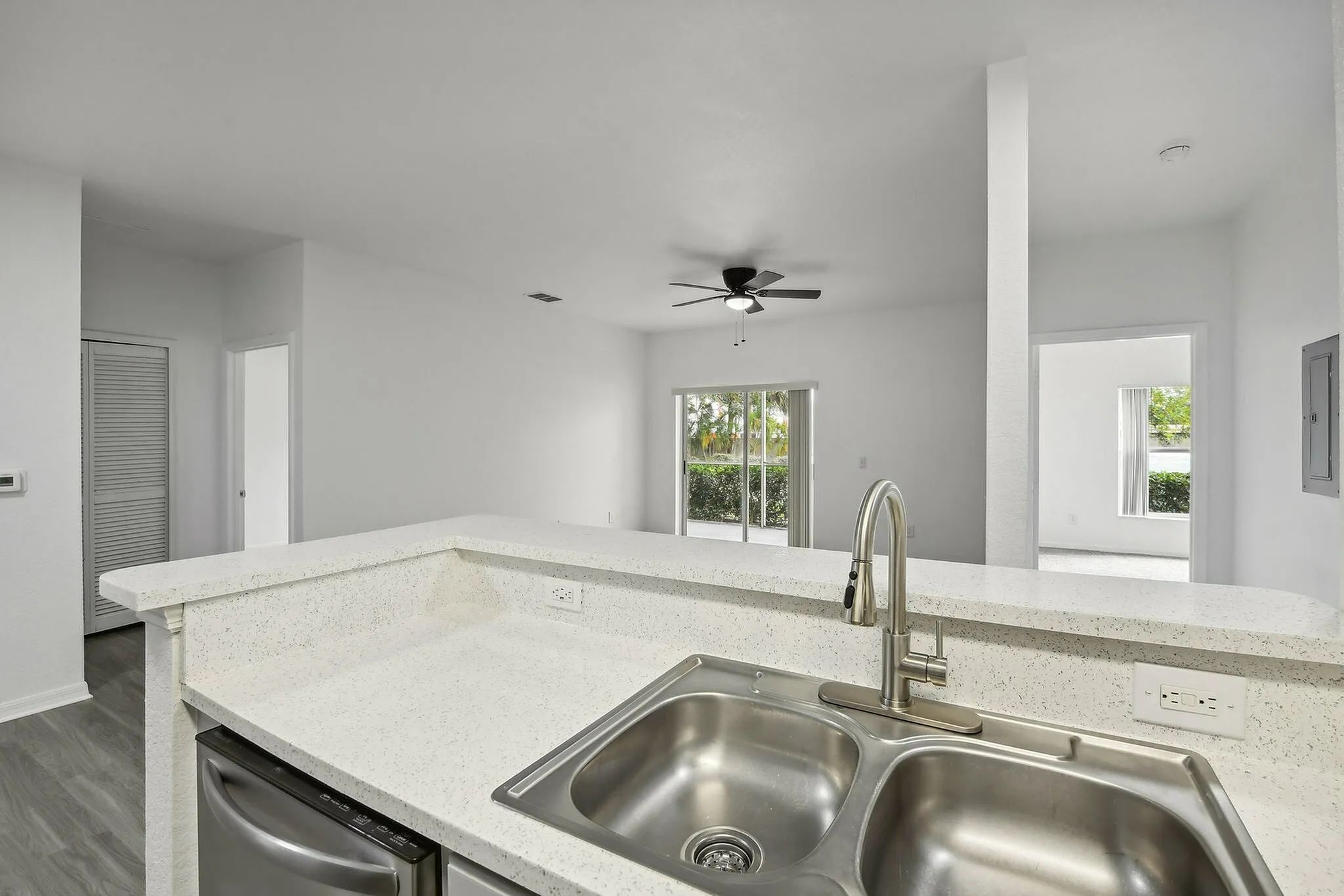 interior pic of deluxe kitchen unit with gray planking and white walls, stainless steel appliances and backsplash