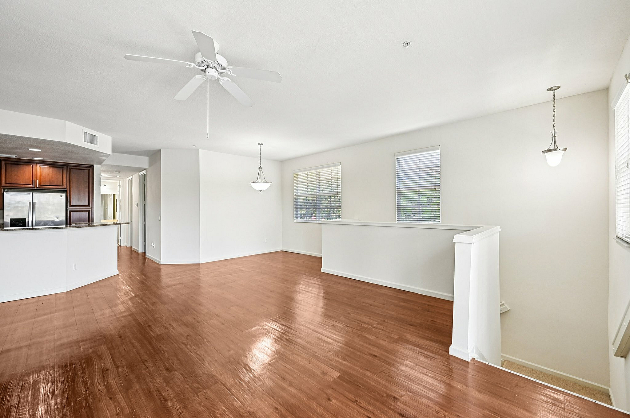 Bright and spacious open-concept living area with modern kitchen, featuring sleek hardwood floors and abundant natural light.