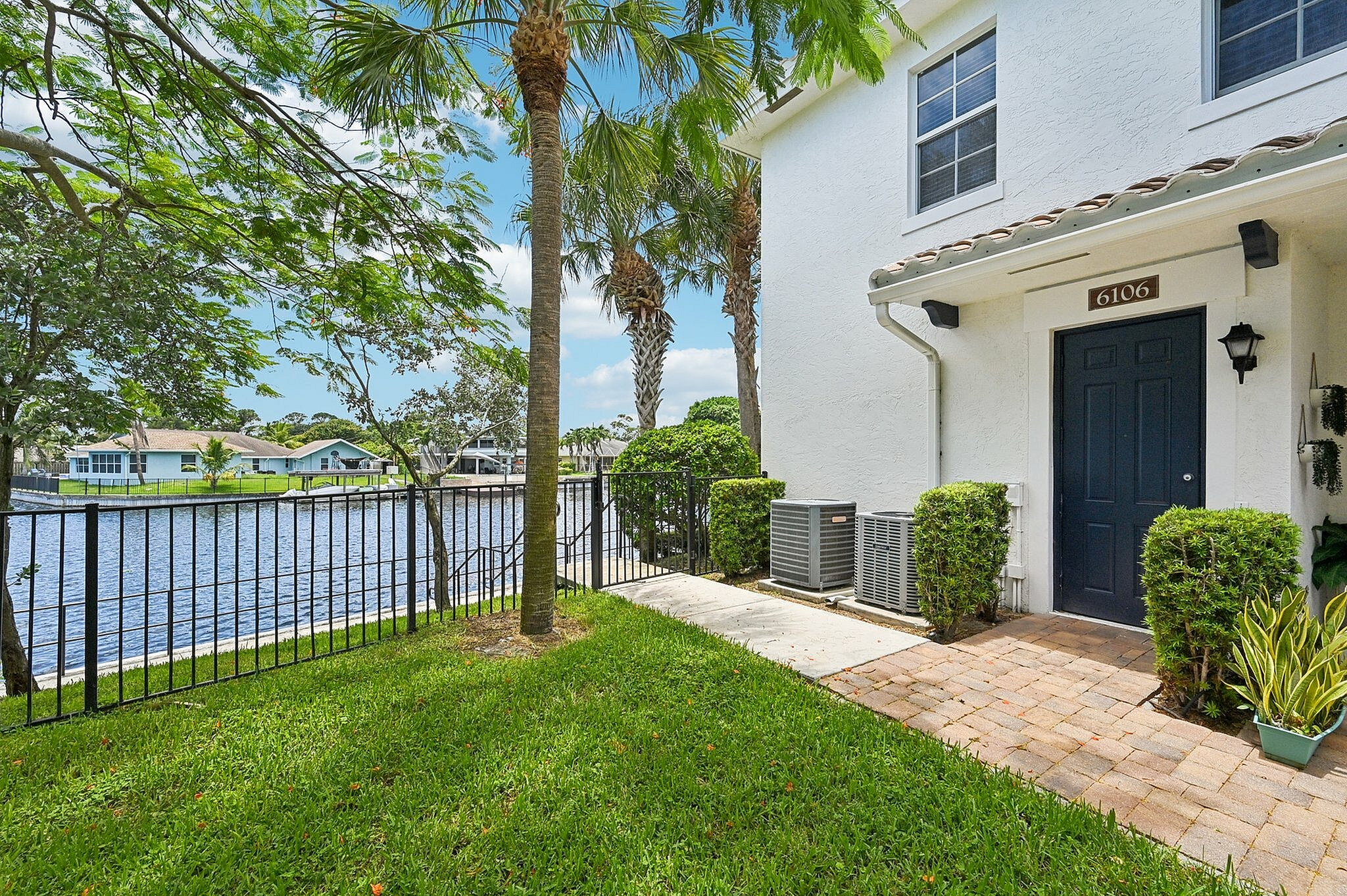 Waterfront townhomes with a lush garden, private entrance, and picturesque lake views.