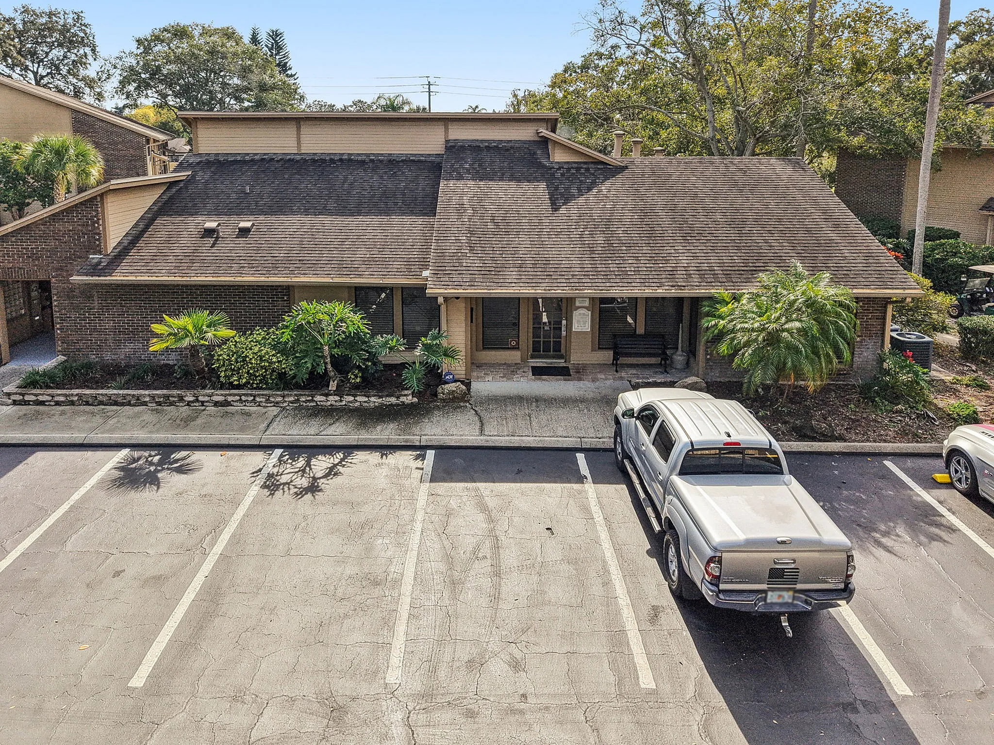 Charming brick building with lush landscaping and convenient parking in a serene neighborhood.