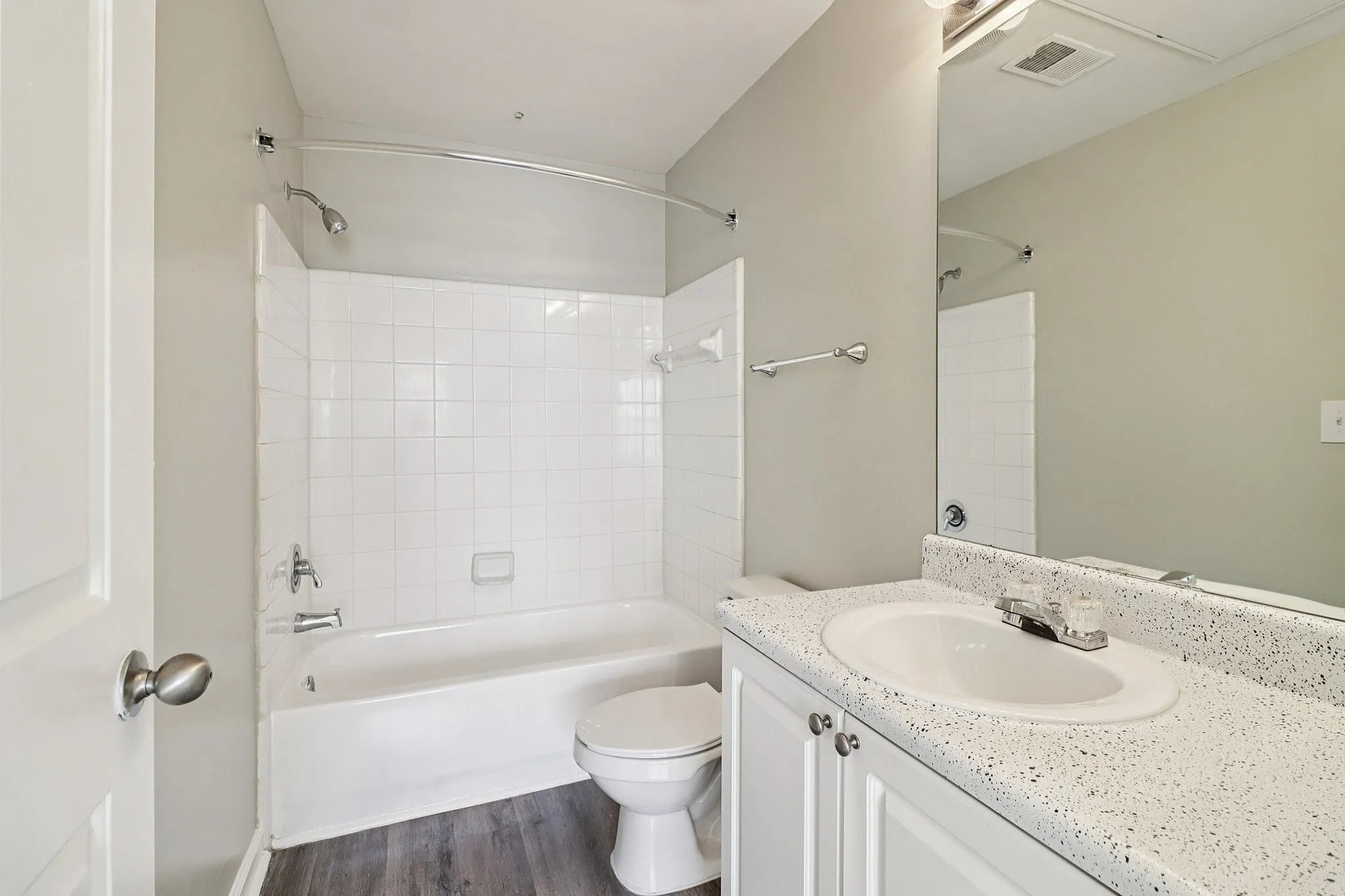 Bright and modern bathroom featuring a sleek vanity, pristine bathtub, and stylish fixtures, perfect for a rejuvenating space.