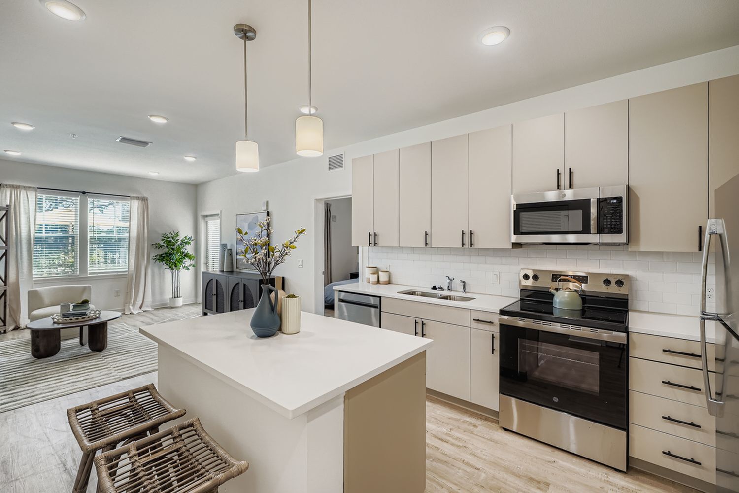 Premium and modern apartment interior featuring a sleek kitchen with stainless steel appliances and an inviting open-plan living area.