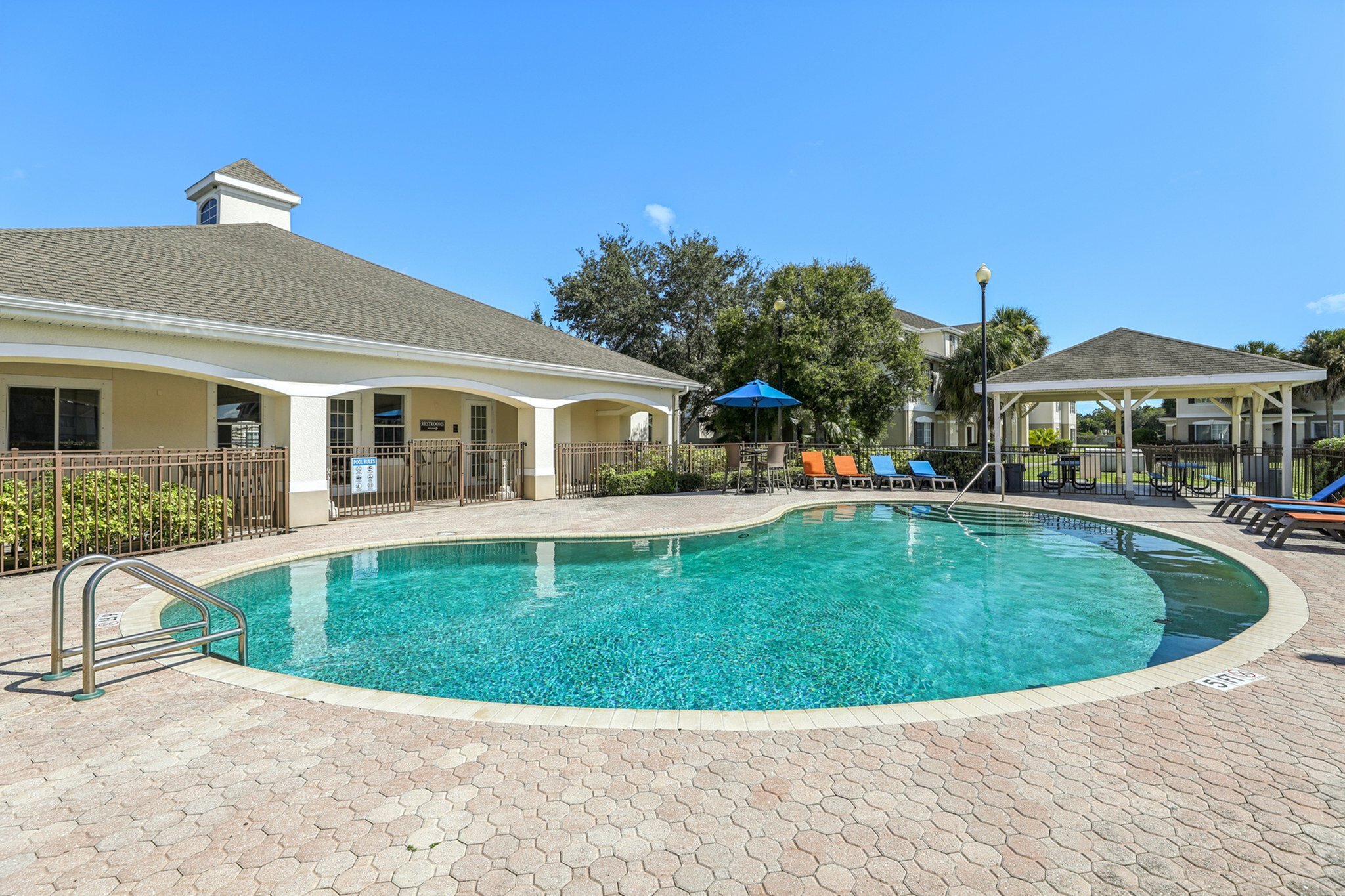 A sparkling pool, sun loungers, and a charming patio area, perfect for relaxation and recreation.